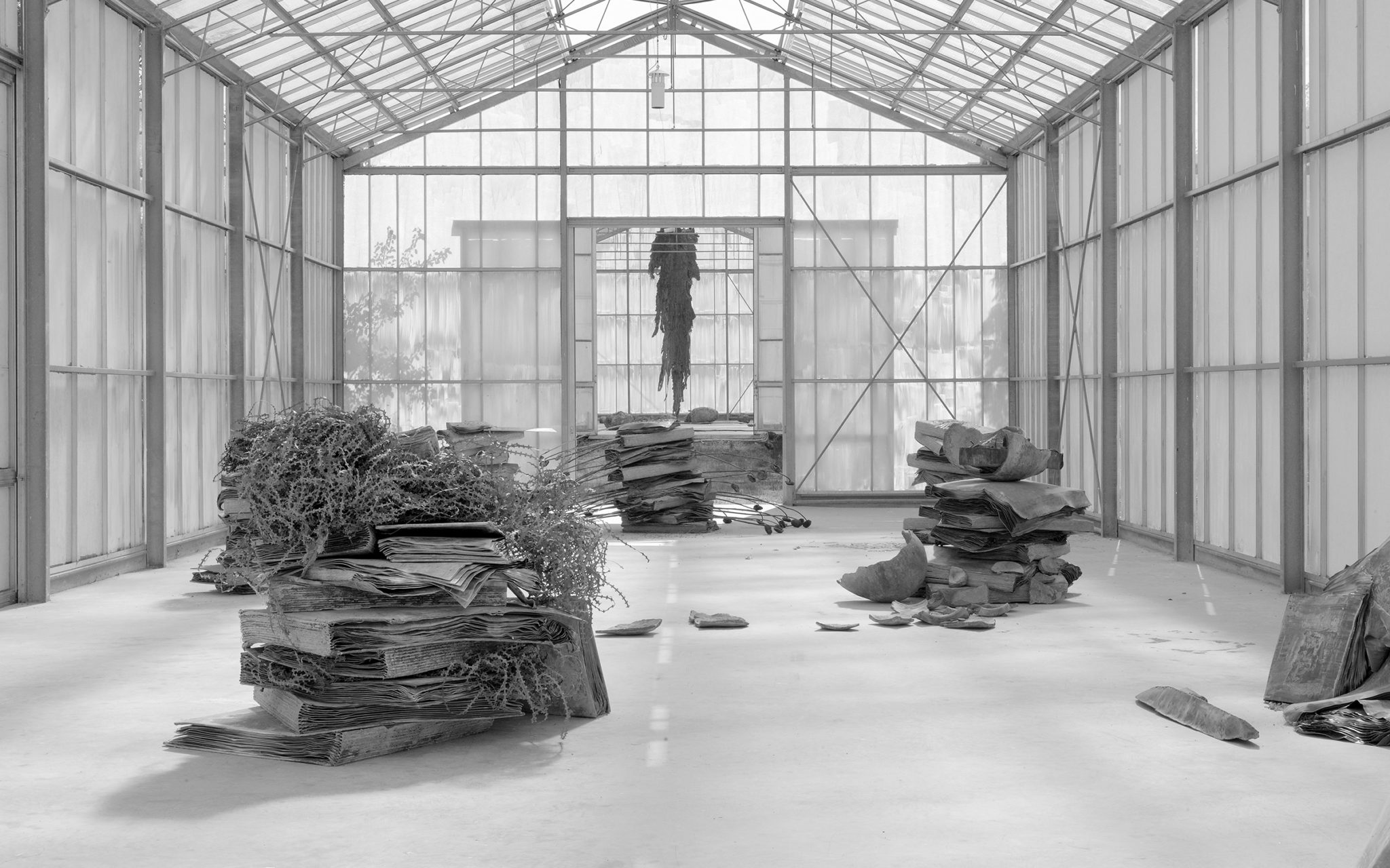 A Large greenhouse with Kiefer's lead book sculptures