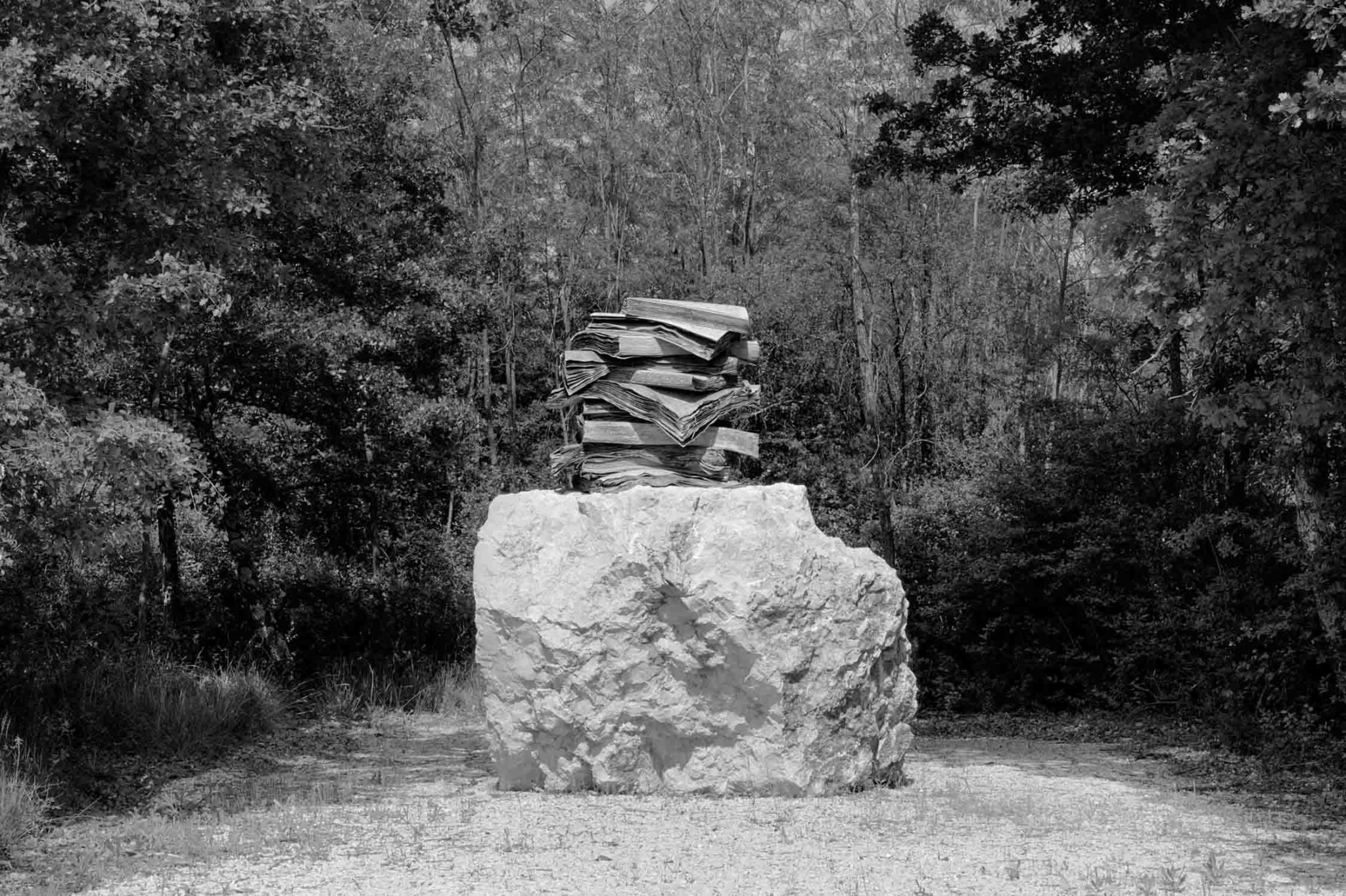 Lead book sculpture on boulder